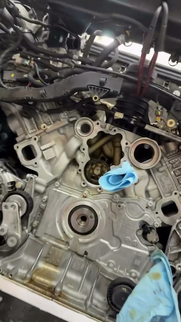 A Porsche engine with the timing cover removed, chain and sprocket exposed.